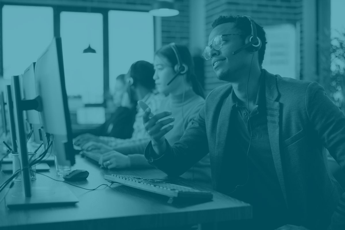 Outsourced IT support helping employees in office