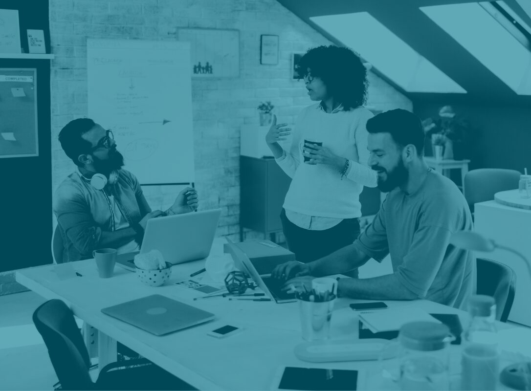 Outsourced IT support helping employees in office