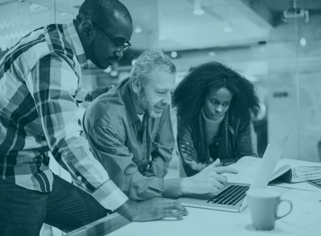 three people from a small business around a computer