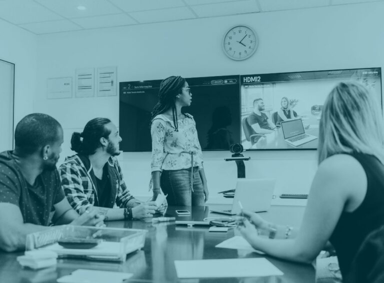 Office workers in meeting room with video conferencing